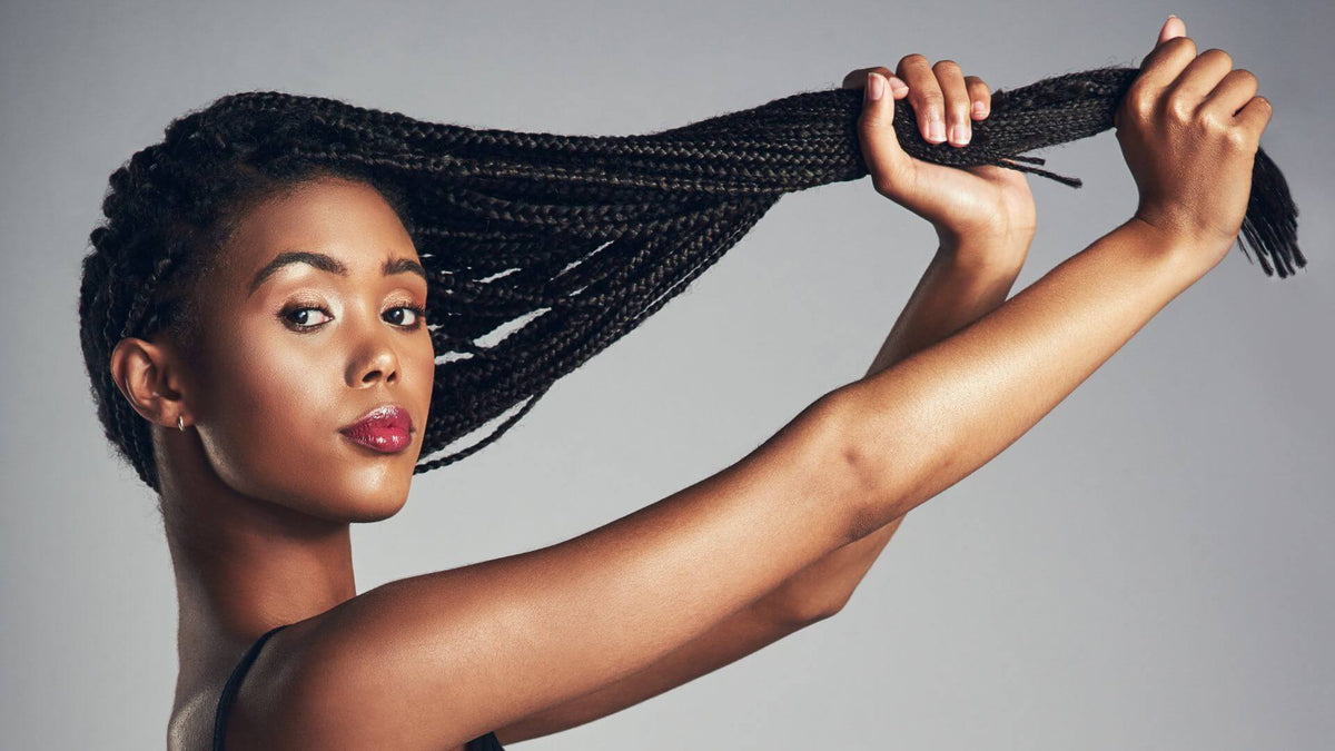 woman holding braids in hand