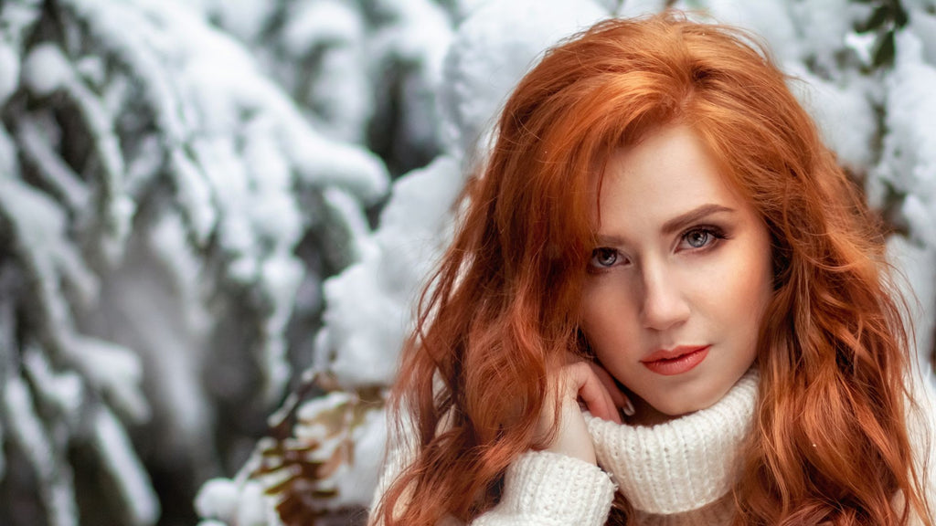 woman with red hair in snow