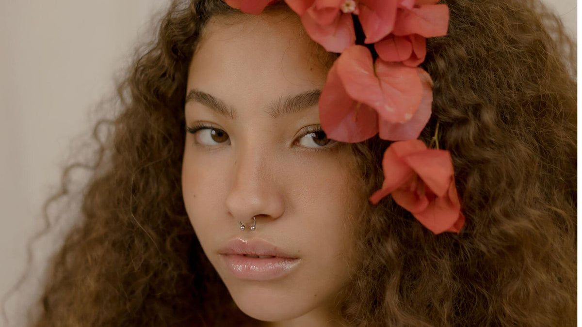 woman with curly hair flower in hair