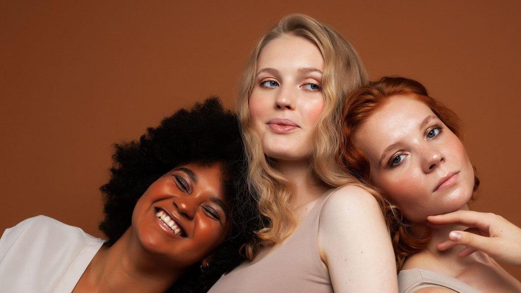 group of three women brown background