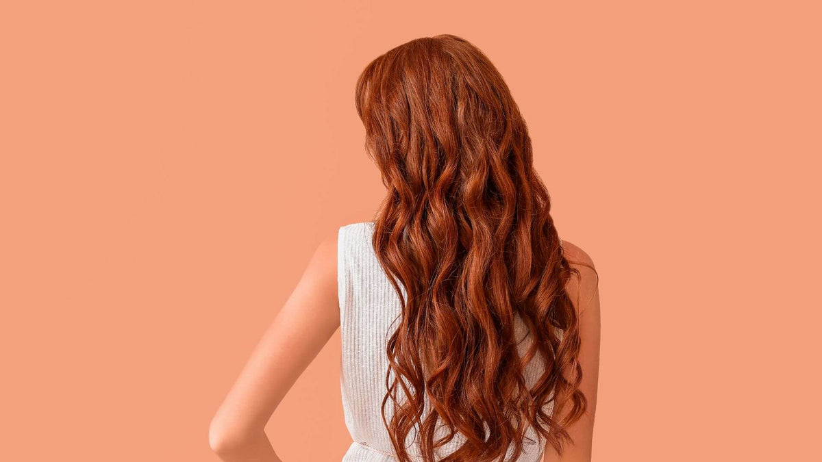 woman with red hair orange background