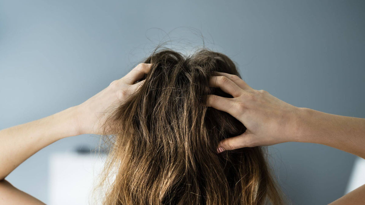 woman with hands in scalp