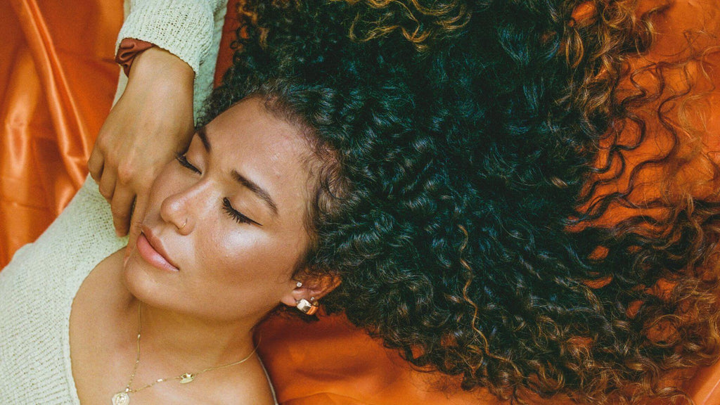 woman with curly hair laying down
