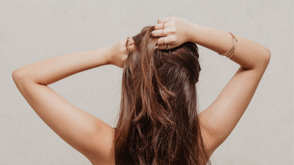 brunette woman hands in hair
