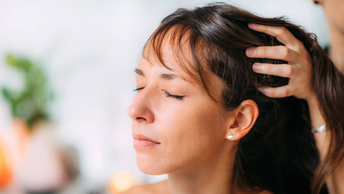 woman with brunette hair hand in scalp