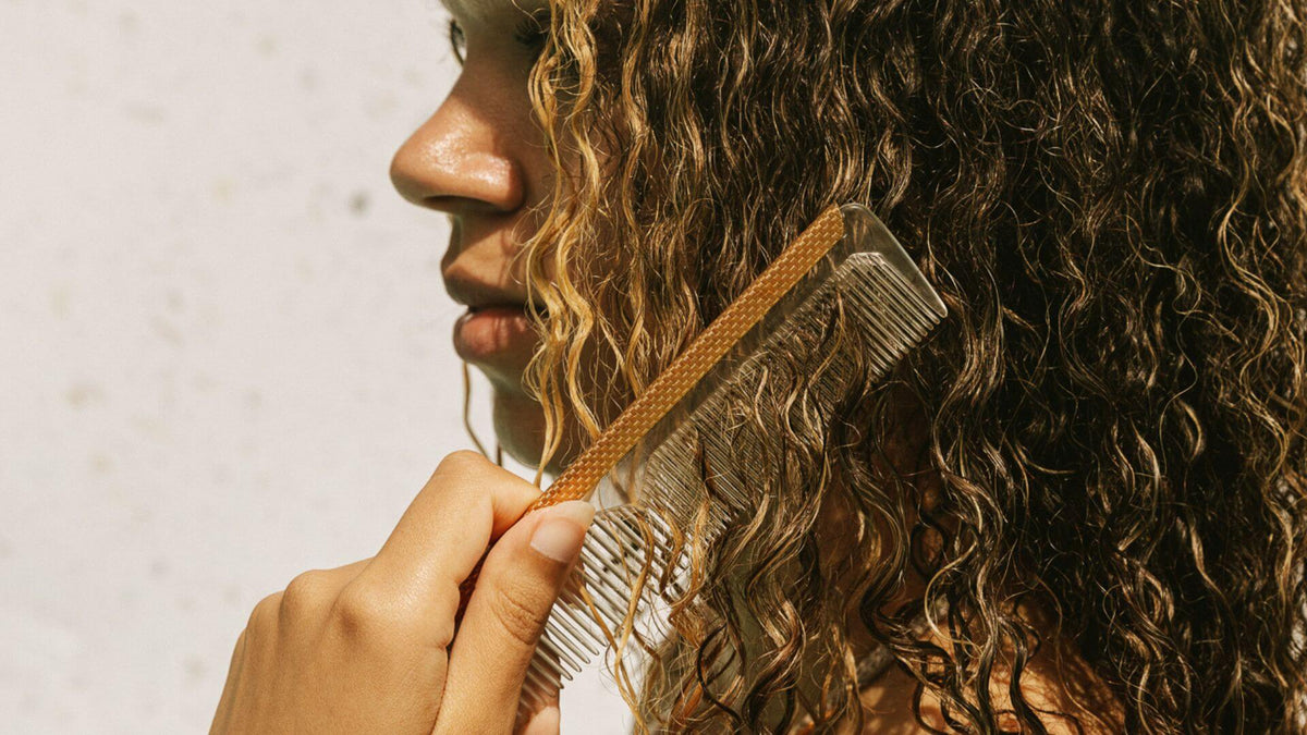 woman with comb in curly hair