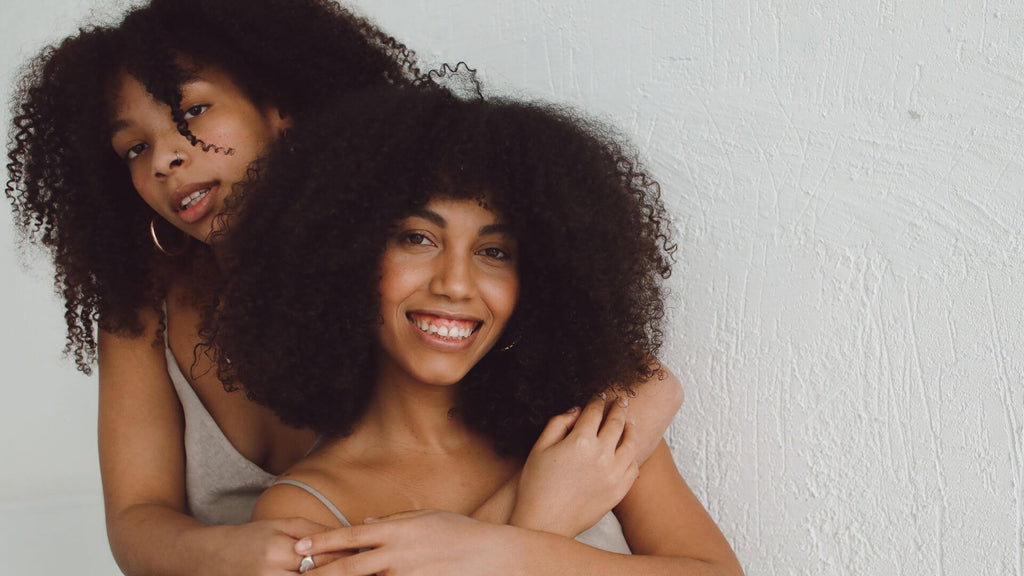 two women with curly hair