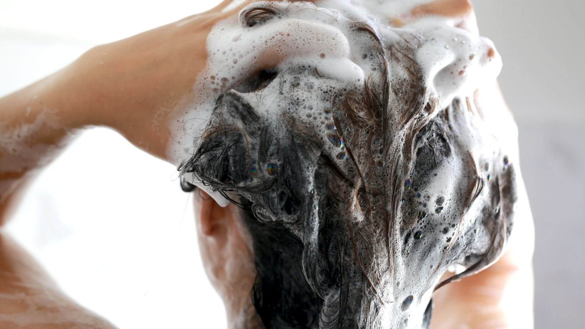 woman with shampoo in hair