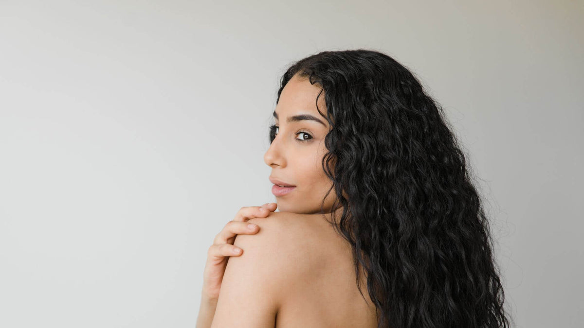 curly hair woman on grey background