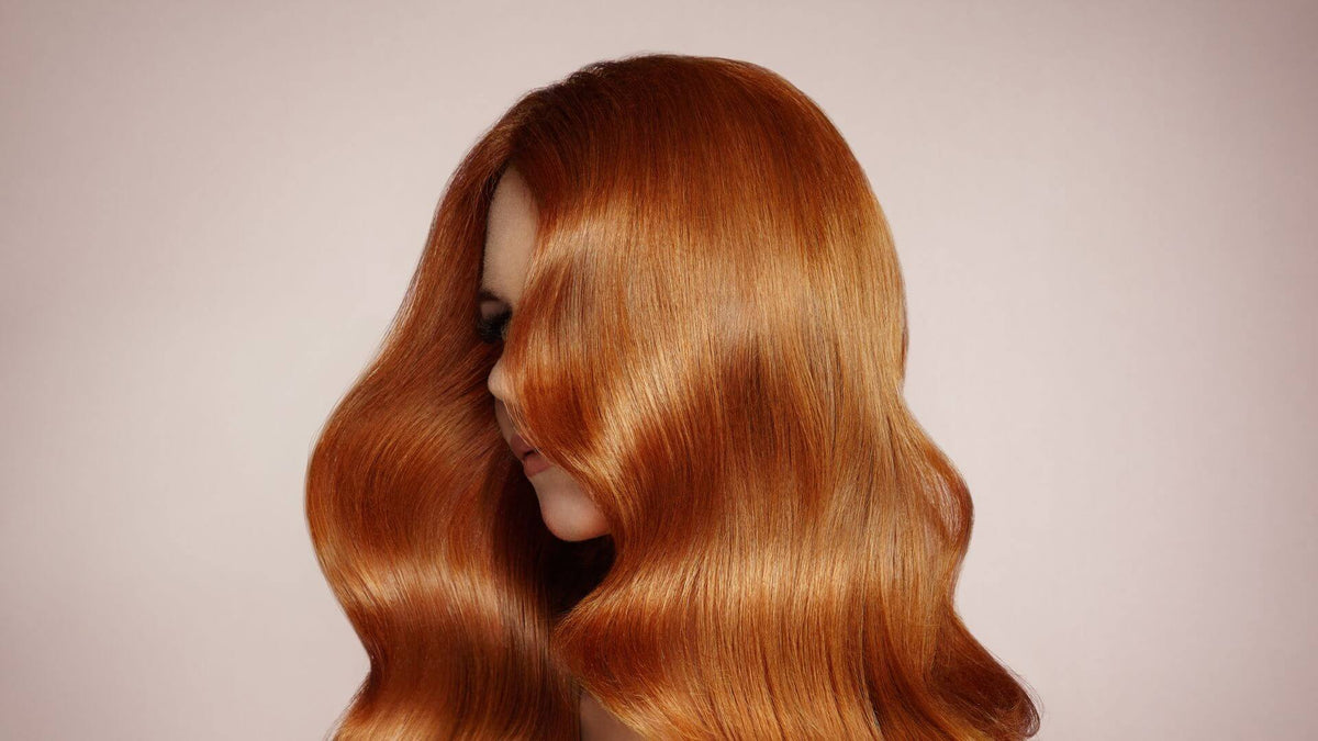 woman with red hair pink background