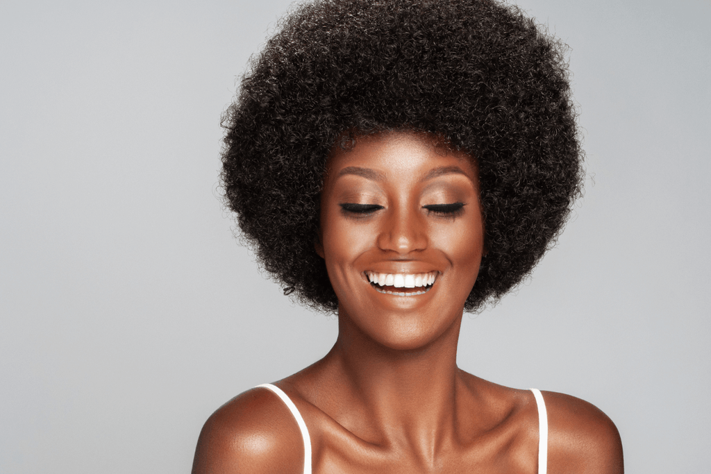 women with afro smiling