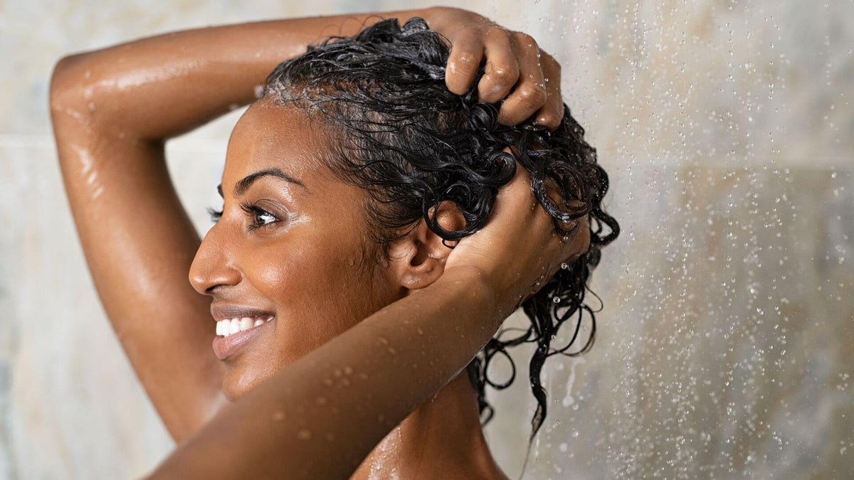 woman washing short curly hair