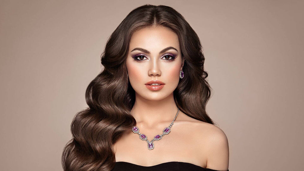 woman with wavy dark hair brown background