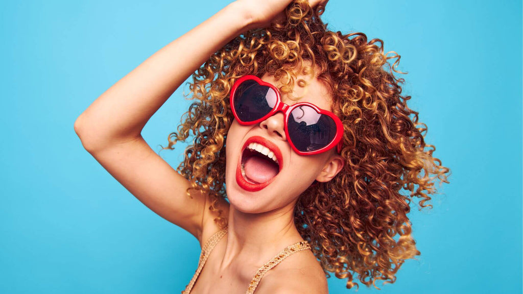 woman with curly hair blue background