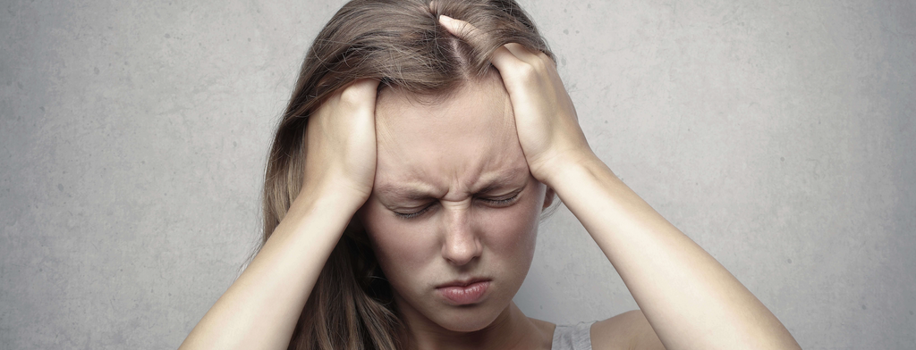 woman frowning hands in hair