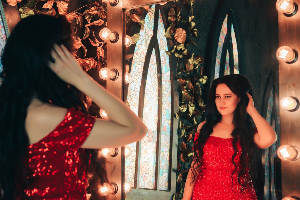 woman looking in the mirror with her hair