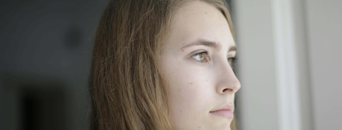 woman sad looking out window