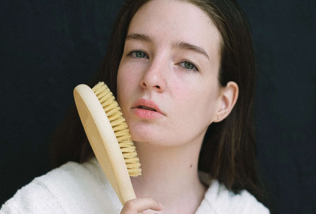 woman brunette hair with hair brush