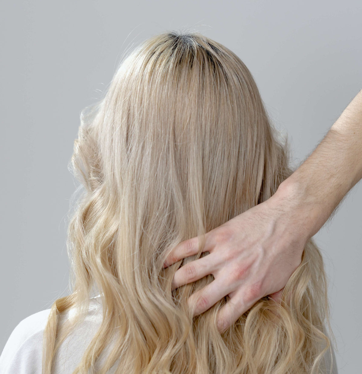 blonde woman curls with hand