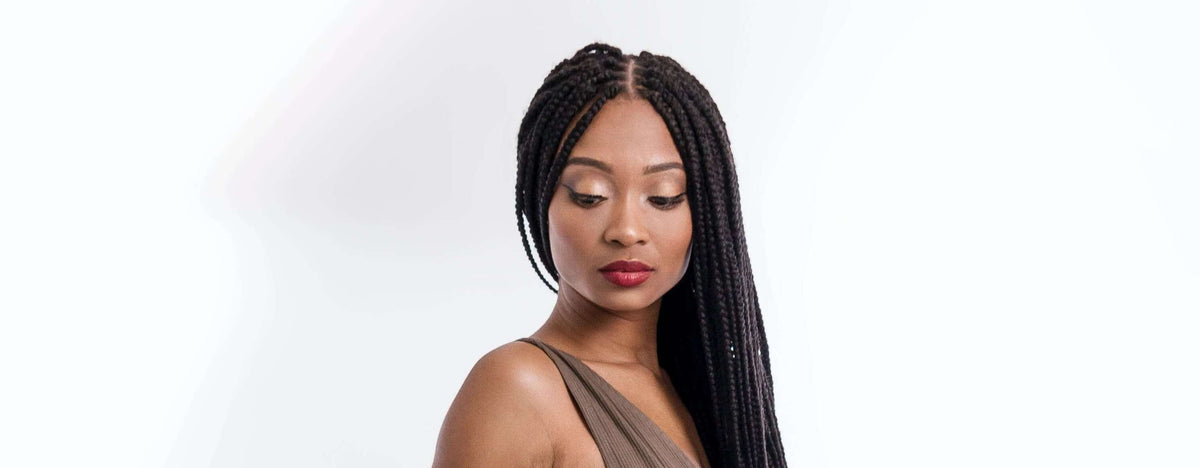 woman looking down braided hair
