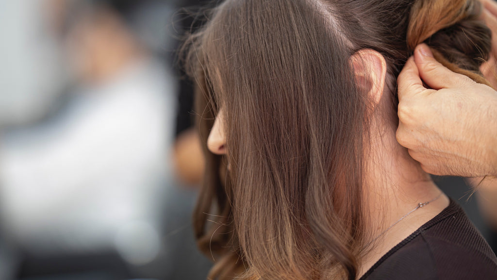brunette woman hair falling out