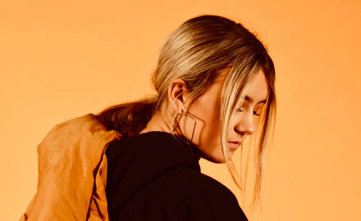 woman with blonde hair orange lighting