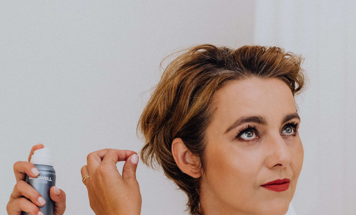 woman styling hair short