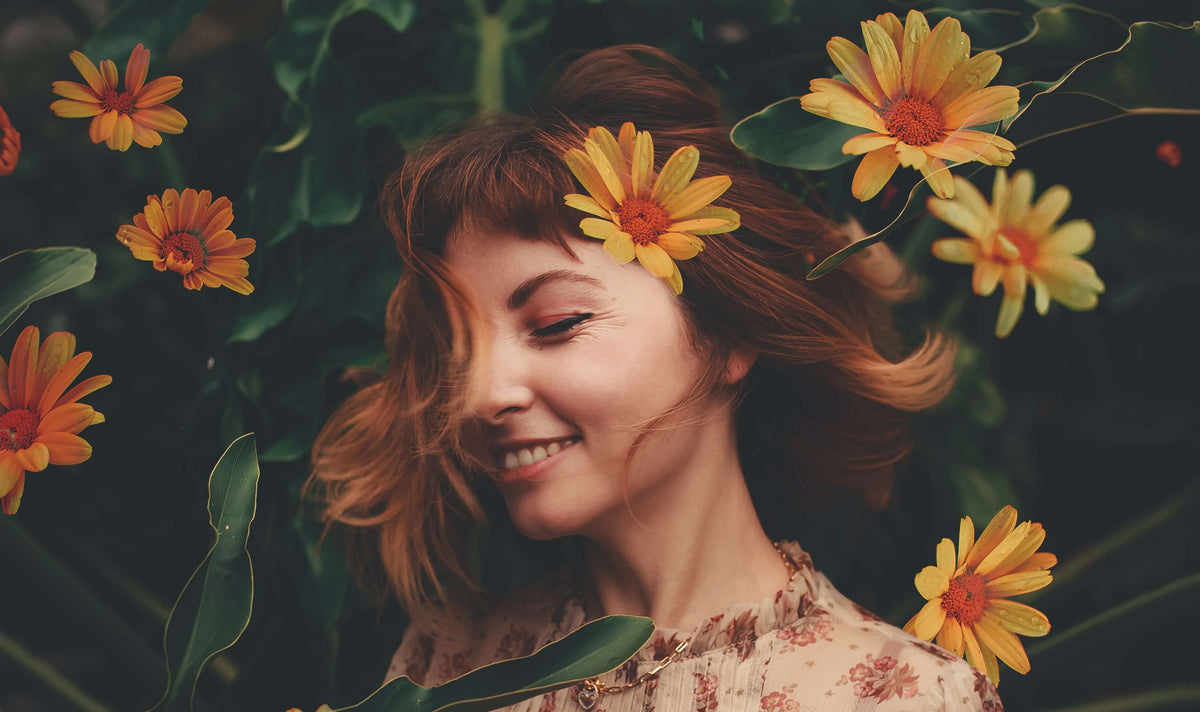brunette woman yellow flowers in hair