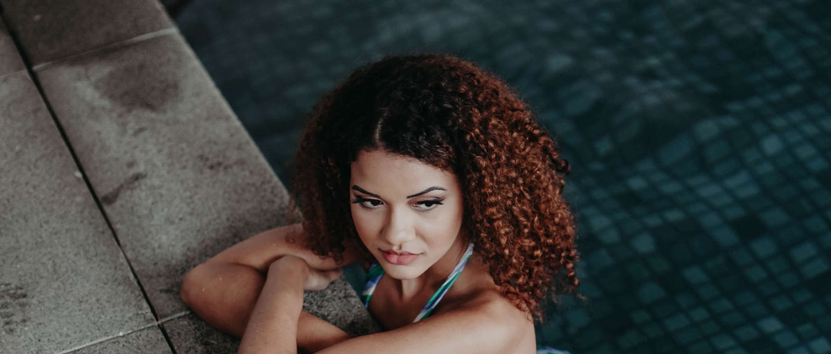 Woman with kinky coily hair in pool