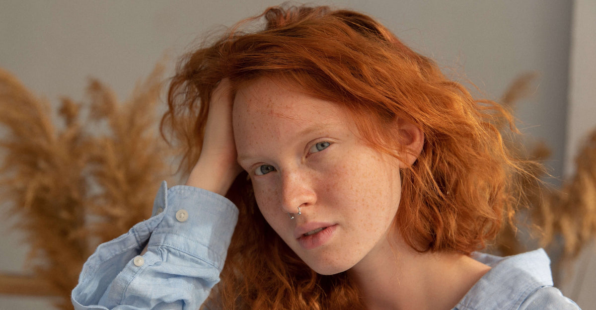 red hair woman with hand in hair