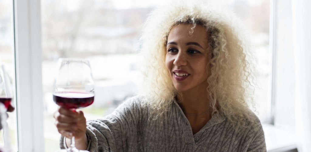 curly hair woman with wine glass