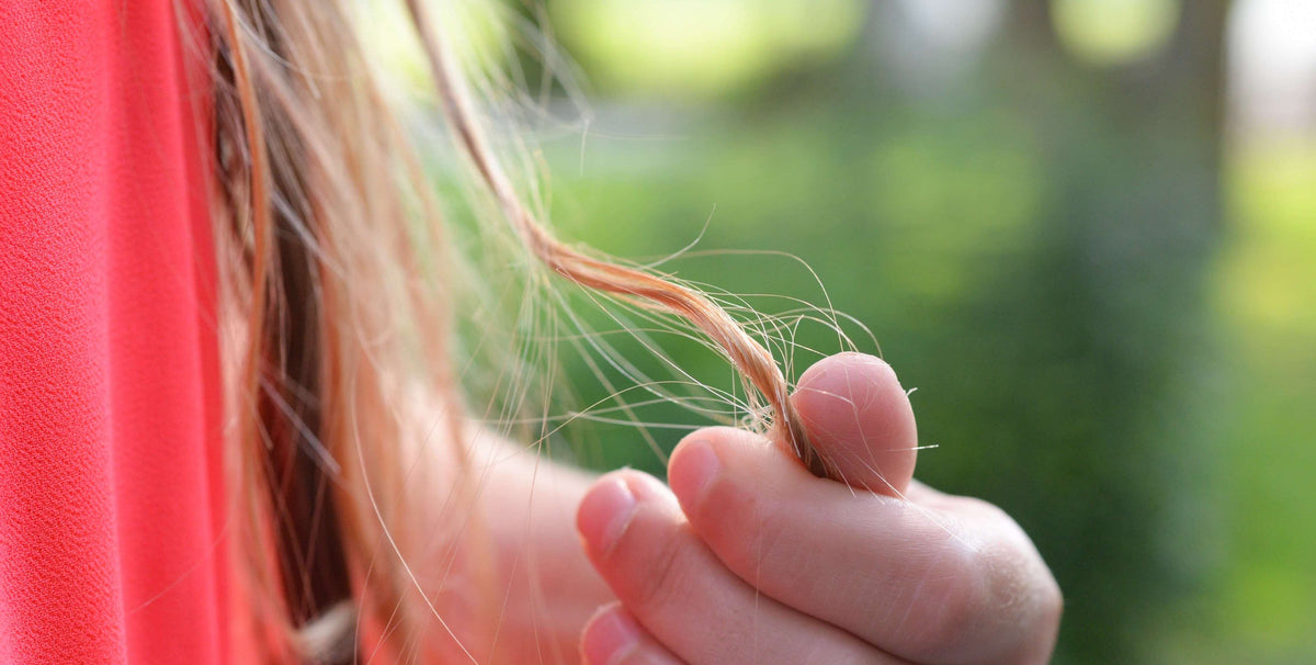 woman holding blonde hair