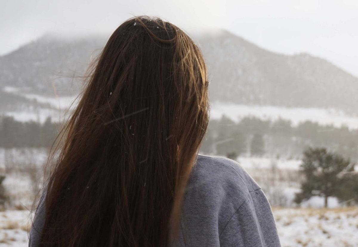 brunette woman with mountains